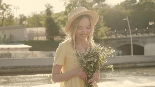 Young beautiful smiling hipster woman in trendy summer sundress posing outdoors alt