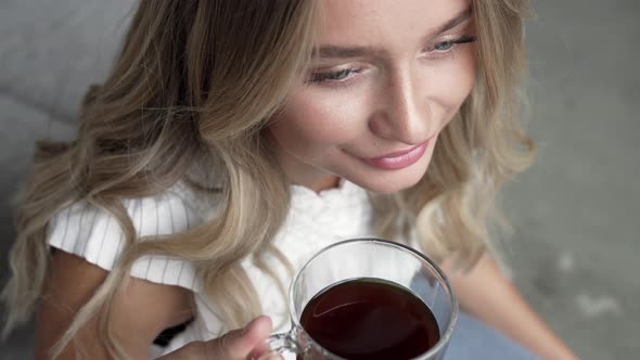 Blond Woman Relaxing And Drinking Coffee