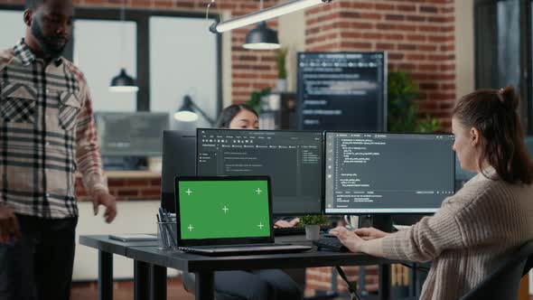 Programer Working at Desk with Multiple Computer Screens and Laptop with Green Screen Chroma Key alt