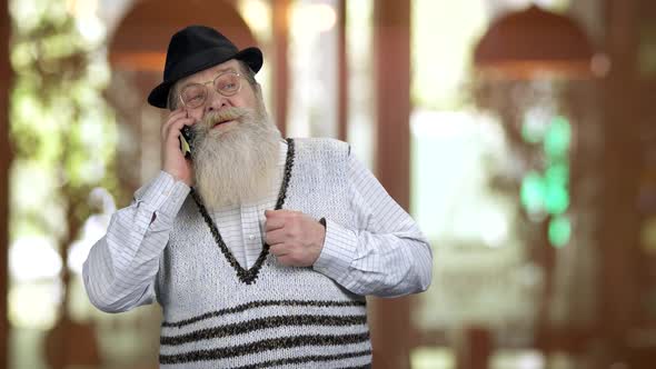 Old Longbearded Retired Grandpa Talking on Phone alt