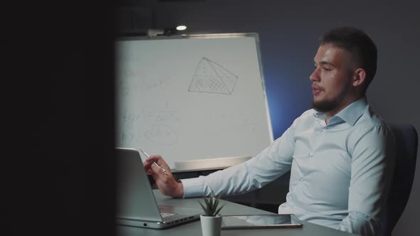 Mixedraised Businessman Making Video Call with the Client and Using Whiteboard During Discussion