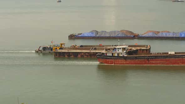 Cargo Ships Float Near Each Other and Transporting Building Materials or Sand alt