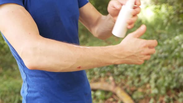 Man Treats the Skin with a Spray From Insects Mosquitoes Ticks Fleas