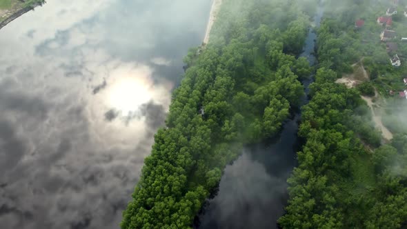 Top View of the River Covered with Clouds and Green Tropical Forest
