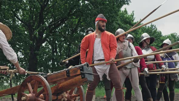 Warriors preparing to the attack and the artilleryist shoot from the cannon alt