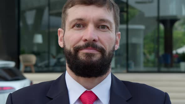 Close Up Portrait Handsome Bearded Senior Businessmanstands on Street Next to a White Car and alt
