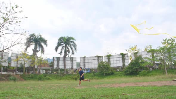 Boy Running With Kite alt