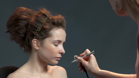 Makeup Artist Using Airbrush. alt