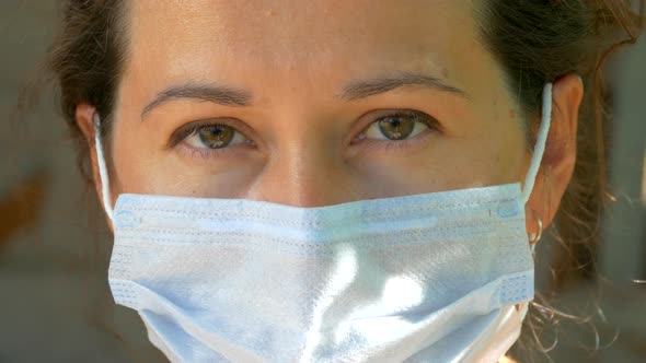 Wearing a medical mask during the Covid epidemic. Close-up of a young woman's face