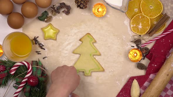 A Young Woman Decorates a Festive Christmas Cookie in the Form of a Christmas Tree with Colored alt