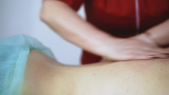 Doctor Does Traditional Massage of Young Female Patient Back alt