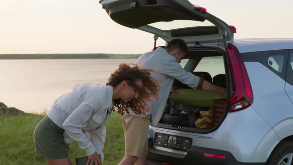 Taking Camping Luggage Out Of Car alt