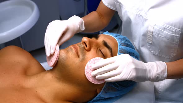 Male patient receiving massage from doctor alt