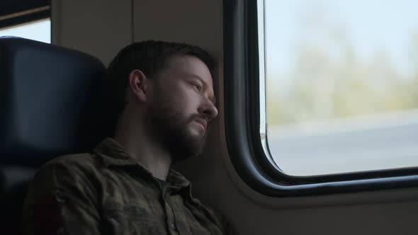 A man looking through the train window	