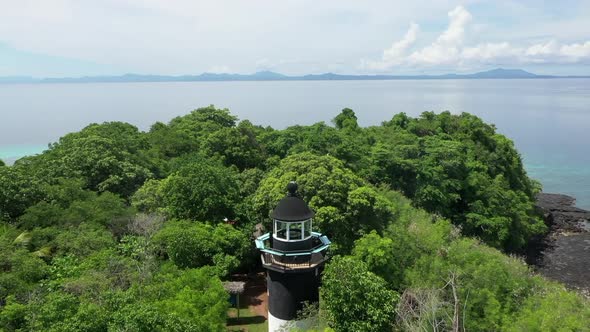 fly over of a lighthouse on a tropical island in the Indian Ocean off Madagascar alt