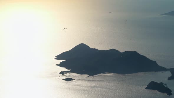 Paragliders Flying With Paragliding in Sky Over the Forest, Mountain Top and Sea alt