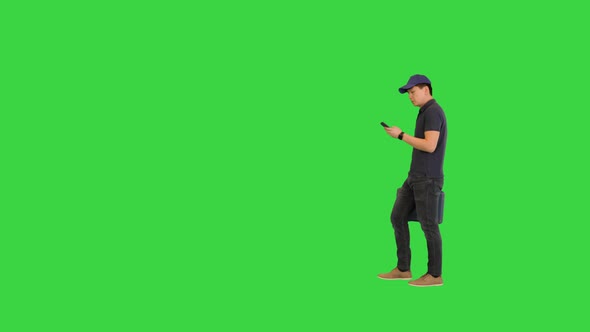 Worker with a Tollbox Arrives at Client's Home Using Mobile Map on a Green Screen Chroma Key alt