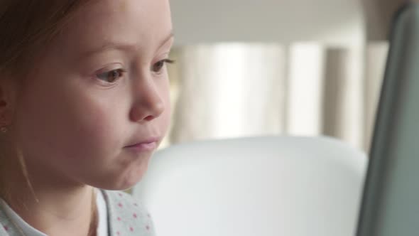 Little Girl Using Touchscreen on Laptop