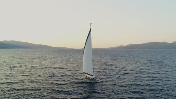 Aerial view of a sailboat anchored in the mediterranean sea, Vathi, Greece. alt