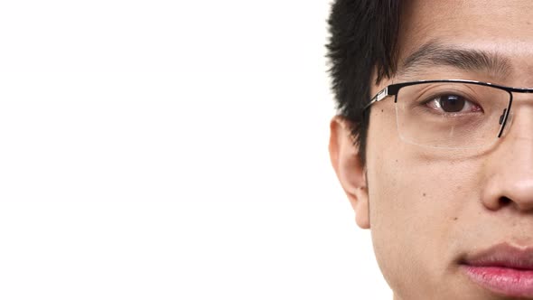 Half Side Portrait Closeup of Young Chinese Man Wearing Eyeglasses Looking at Camera with Meaningful alt