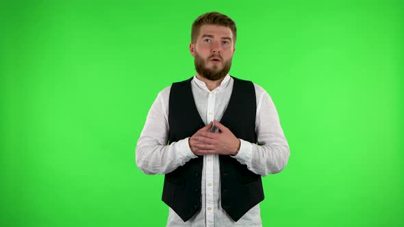 Man Listens To Information Looking at Camera, Is Shocked and Very Upset. Green Screen alt