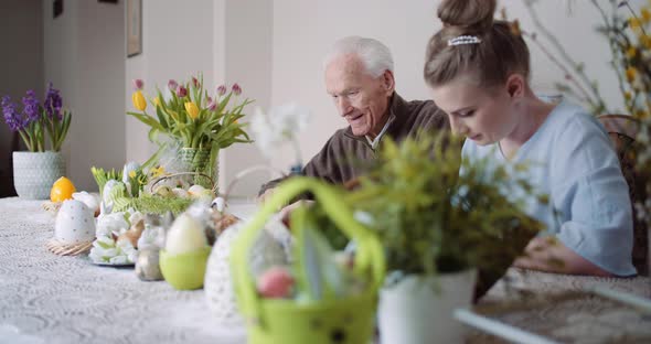 Grandfather and Granddaughter Writing Easter Cards Greetings To Loving Family. alt