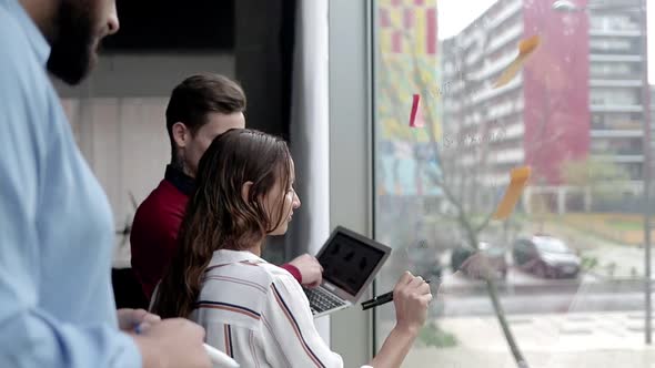 Creative Business Team Analyzing Content on Laptop alt