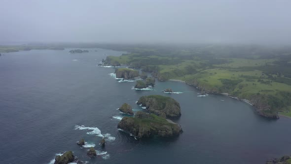 Beautiful Unnamed Bay in Shikotan Island. Drone Flying in a Clouds. Coastline of Pacific Ocean.