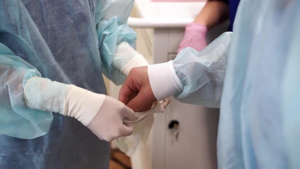 Surgeon Putting Protective Gloves on Before Operation