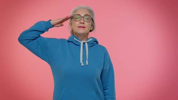 Mature Old Grandmother Giving Salute Listening to Order As If Soldier Following Discipline Obeying alt
