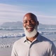 Senior african american man smiling at the beach