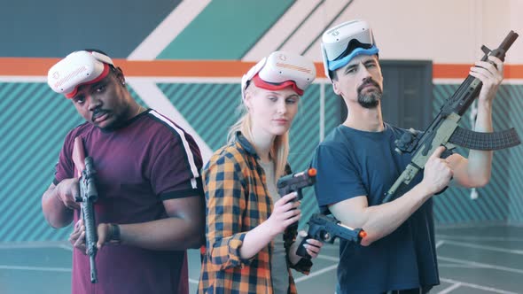Team of Players with VR Glasses and Fake Weapon alt