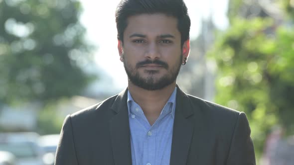 Young Happy Bearded Indian Businessman in Suit Smiling Outdoors alt