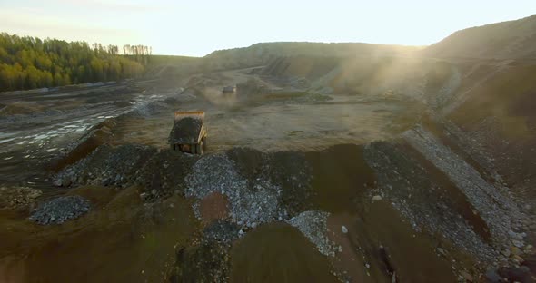 Dump Trucks Unload the Ground and Stones