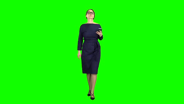Girl Is Holding the Phone Dials the Message and Paces. Green Screen alt
