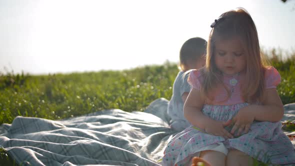 Closeup of Daughter Cute Playing with Blade of Grass alt