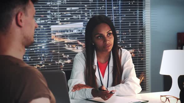 Close-up of Black Family Consultant Reconciling Woman and Man. The Couple Embracing Themselves alt