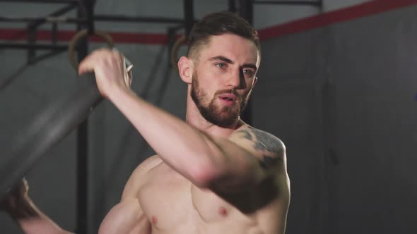 Bearded Tattooed Ripped Athletic Man Working Out at the Crossfit Gym alt