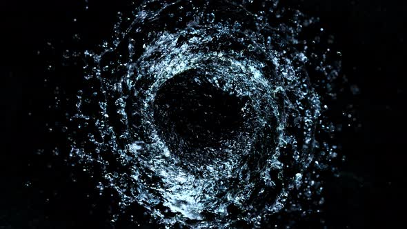 Super Slow Motion Shot of Rotating Water Splash Isolated on Black Background at 1000Fps alt