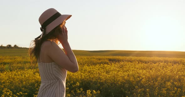 A Smiling Girl Is Talking on the Phone and Jumping Up and Down with Joy alt