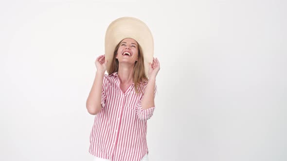 Woman Catching and Putting on Hat