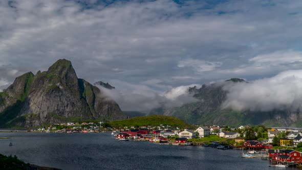 The movement of clouds over a small fishing village in Norway alt