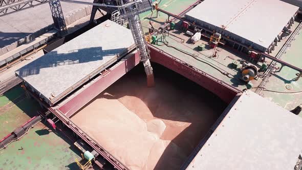 Loading Grain Onto a Cargo Ship for Transportation By Sea By a Conveyor Belt Machine