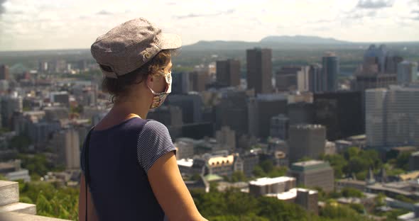 Woman Wearing Mask Looking at Beautiful City Observatory alt