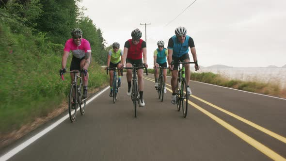 Tracking shot of a group of cyclists on country road.  Fully released for commercial use.