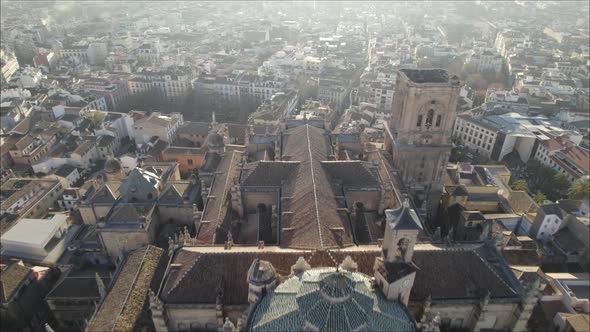 Aerial forward view over the cathedral and its wide city. Granada. Spain