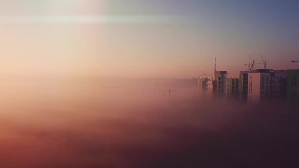 Dawn Flight Over the Field and Houses Morning Fog