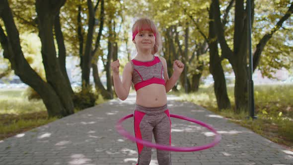 Athletic Fitness Toddler Girl Training Playing Twisting Hula Hoop Circle Ring Around Waist in Park alt