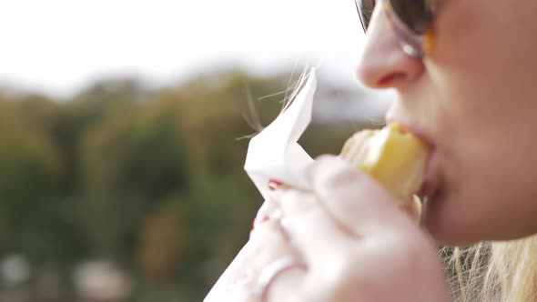 Woman drinking coffee on a cold day outside alt