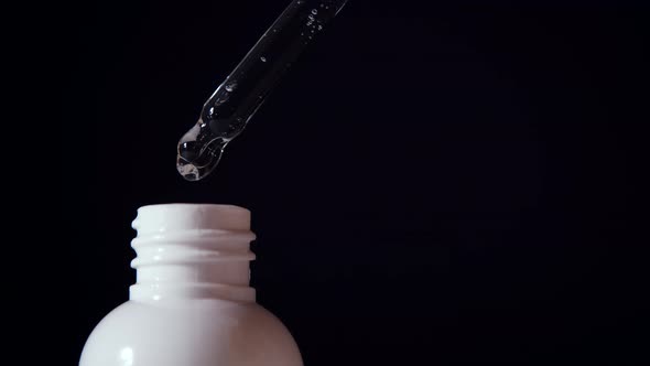 Closeup of Serum Drops Falling From the Pipette